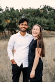 A man standing next to a woman in a field