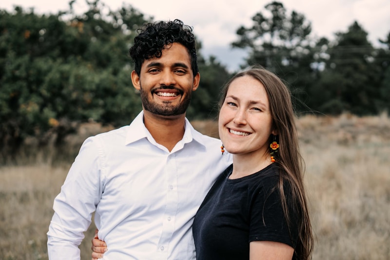 A man standing next to a woman in a field