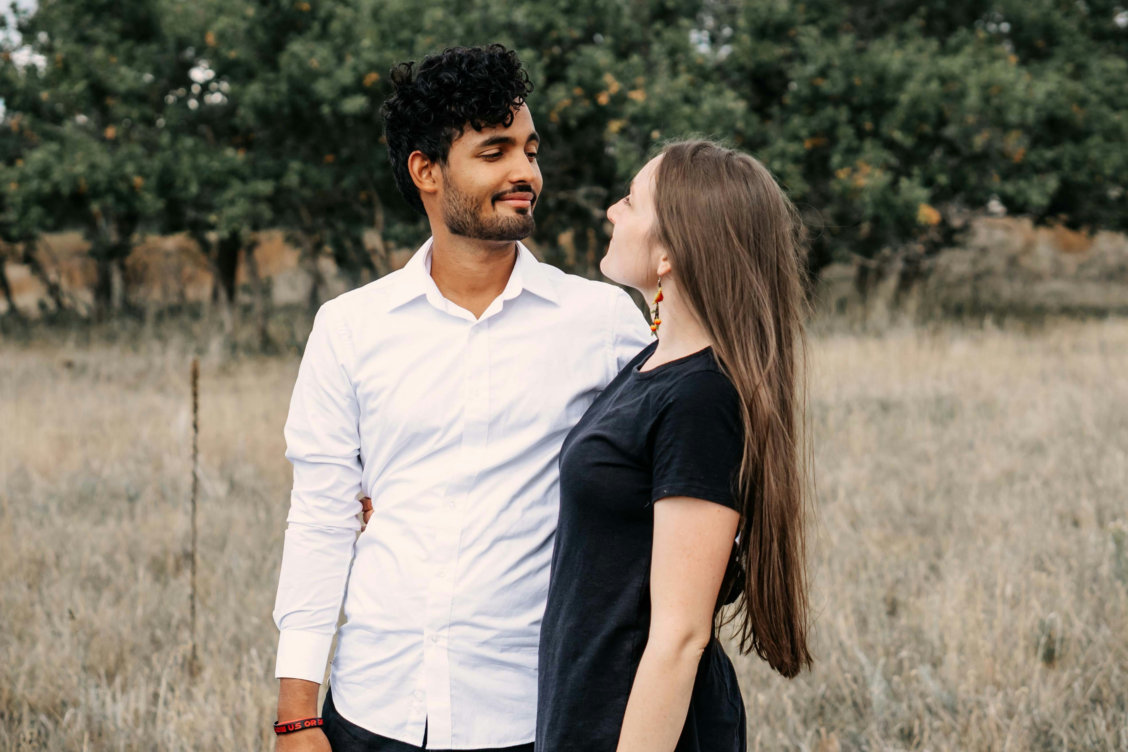 A man and a woman standing in a field