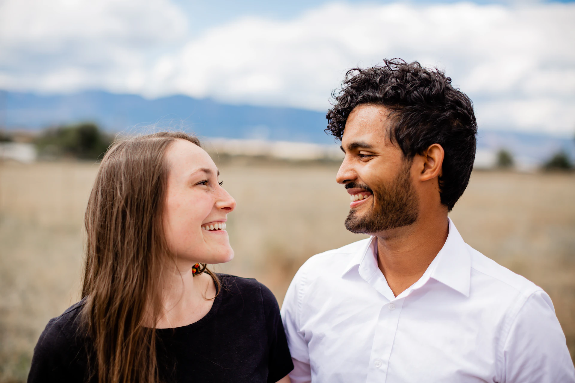 A man standing next to a woman in a field
