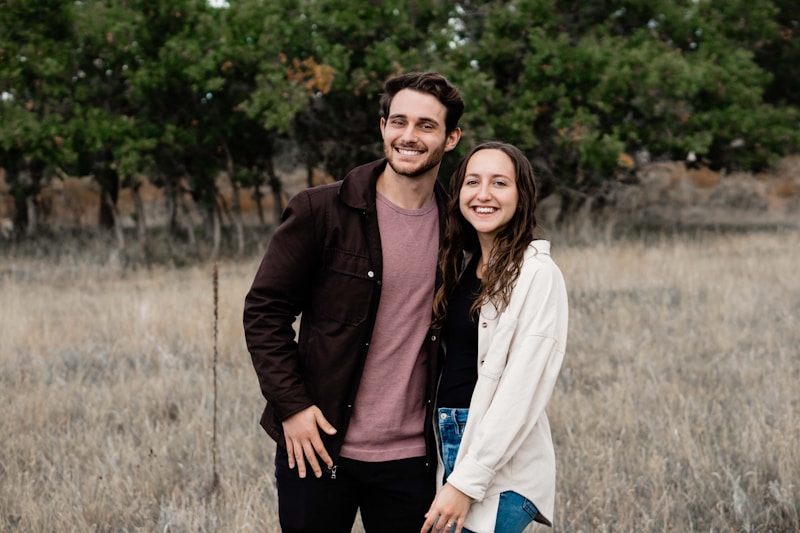A man and a woman standing in a field