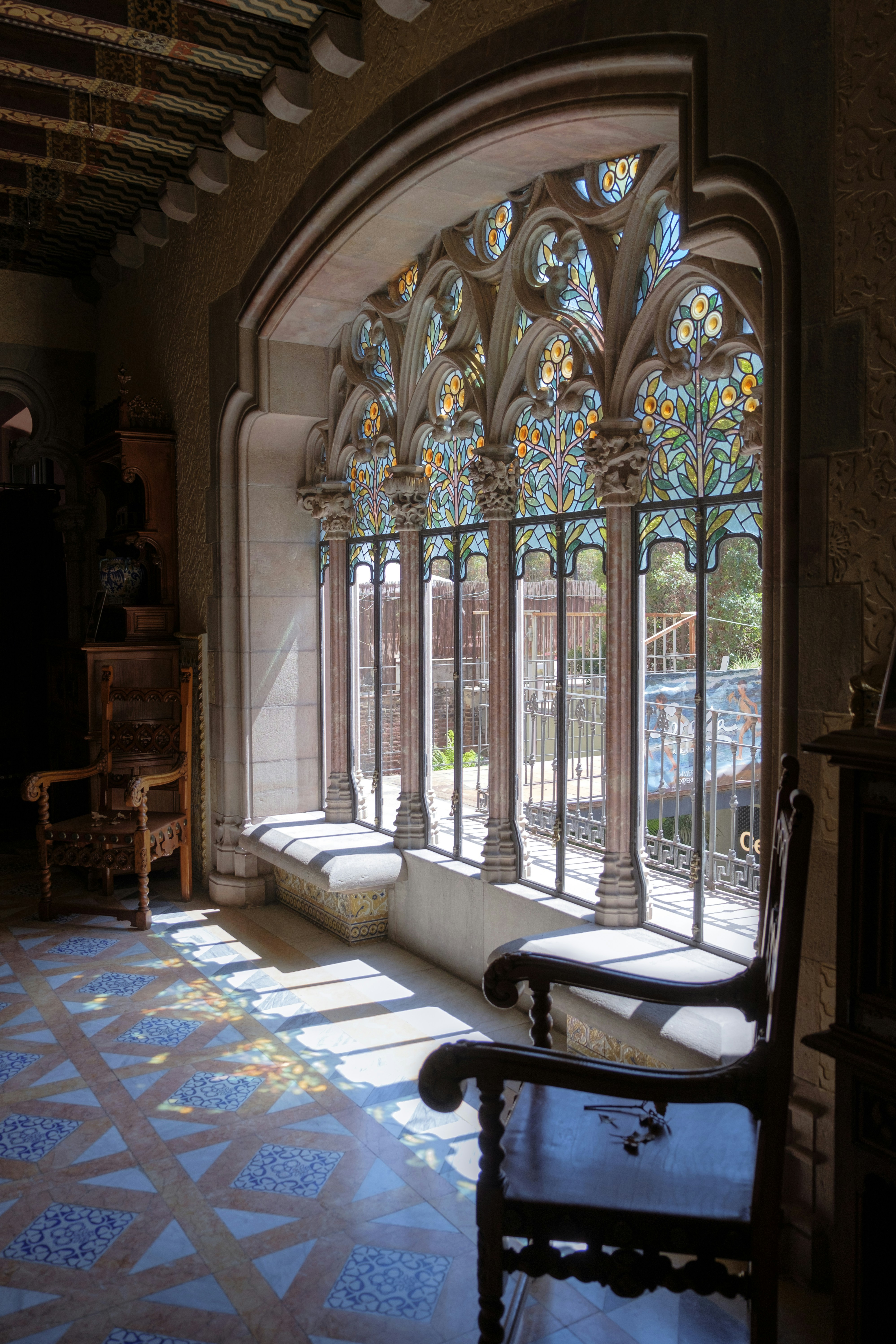 A room with a large arched window and a bench photo – Free Building ...