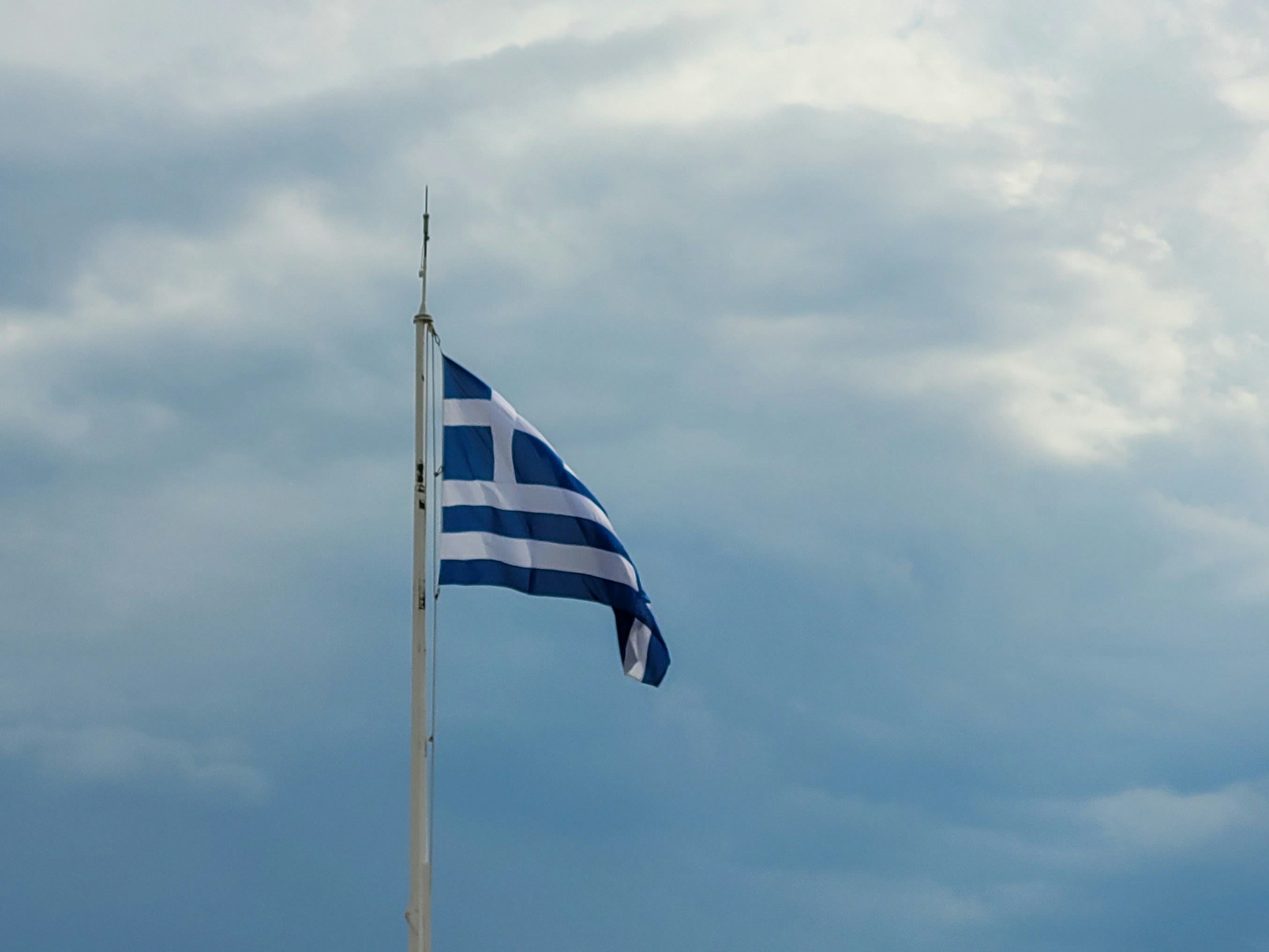 A flag flying in the wind on a cloudy day