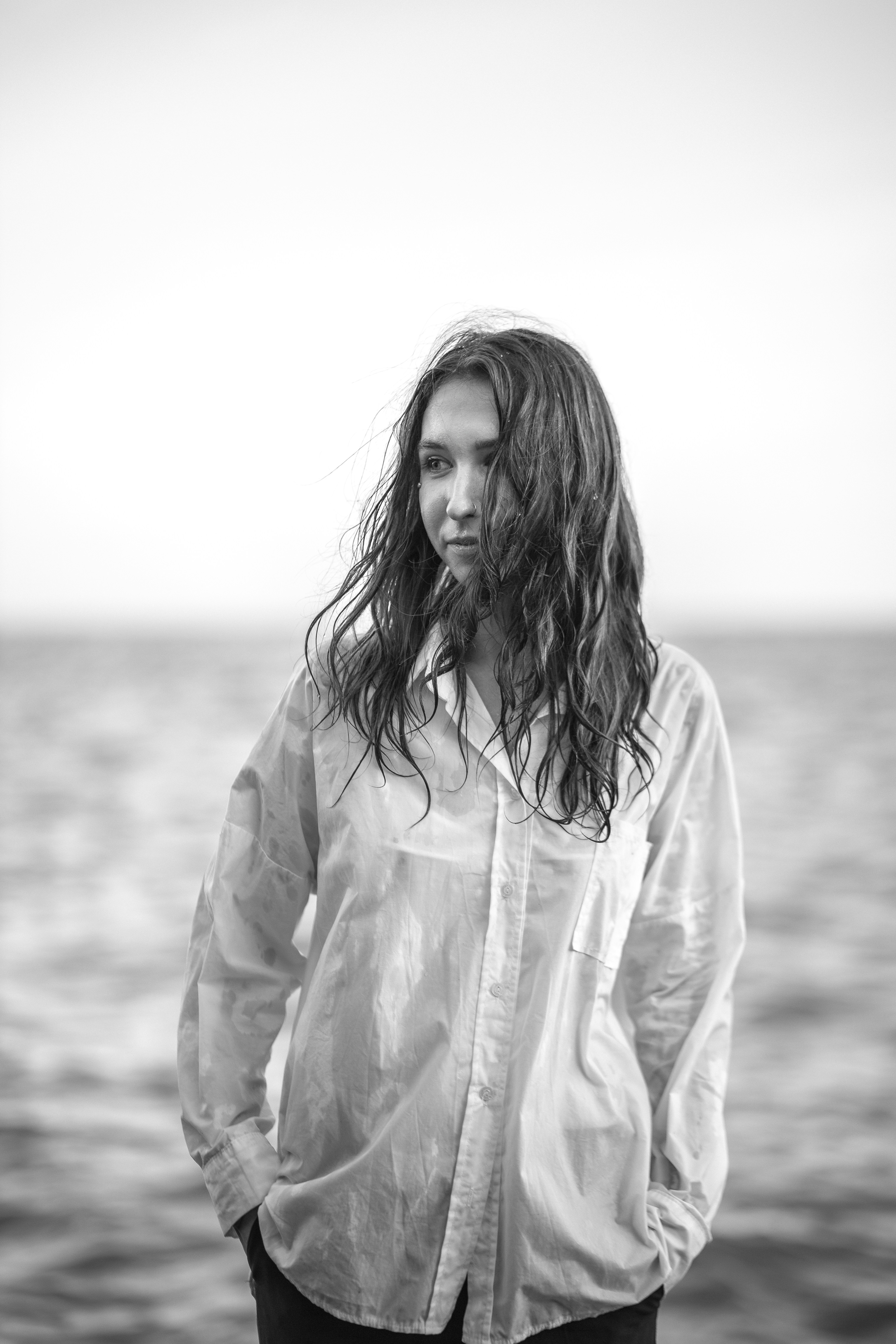 A woman standing in front of a body of water
