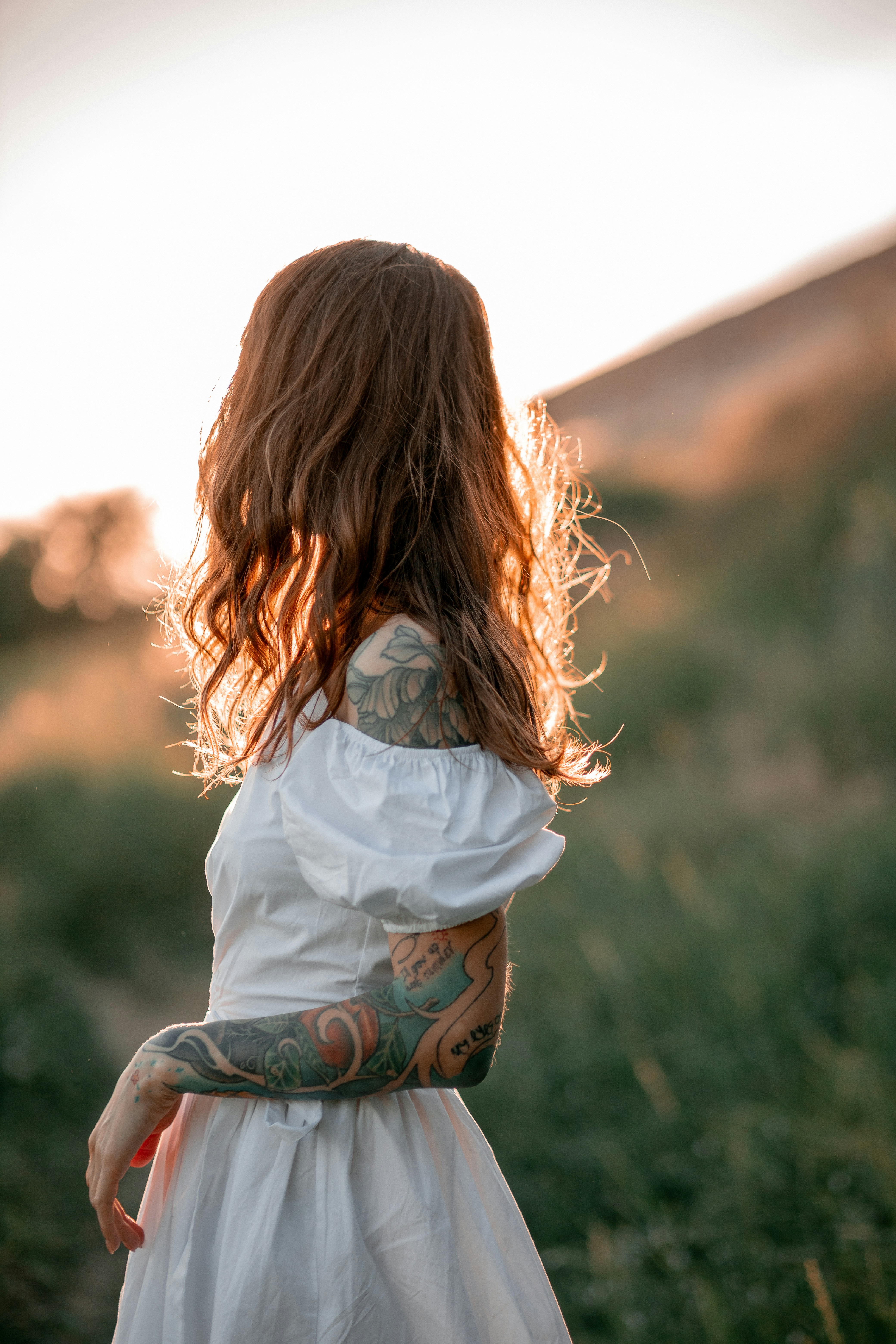 A woman in a white dress standing in a field