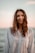 A woman standing in front of a body of water