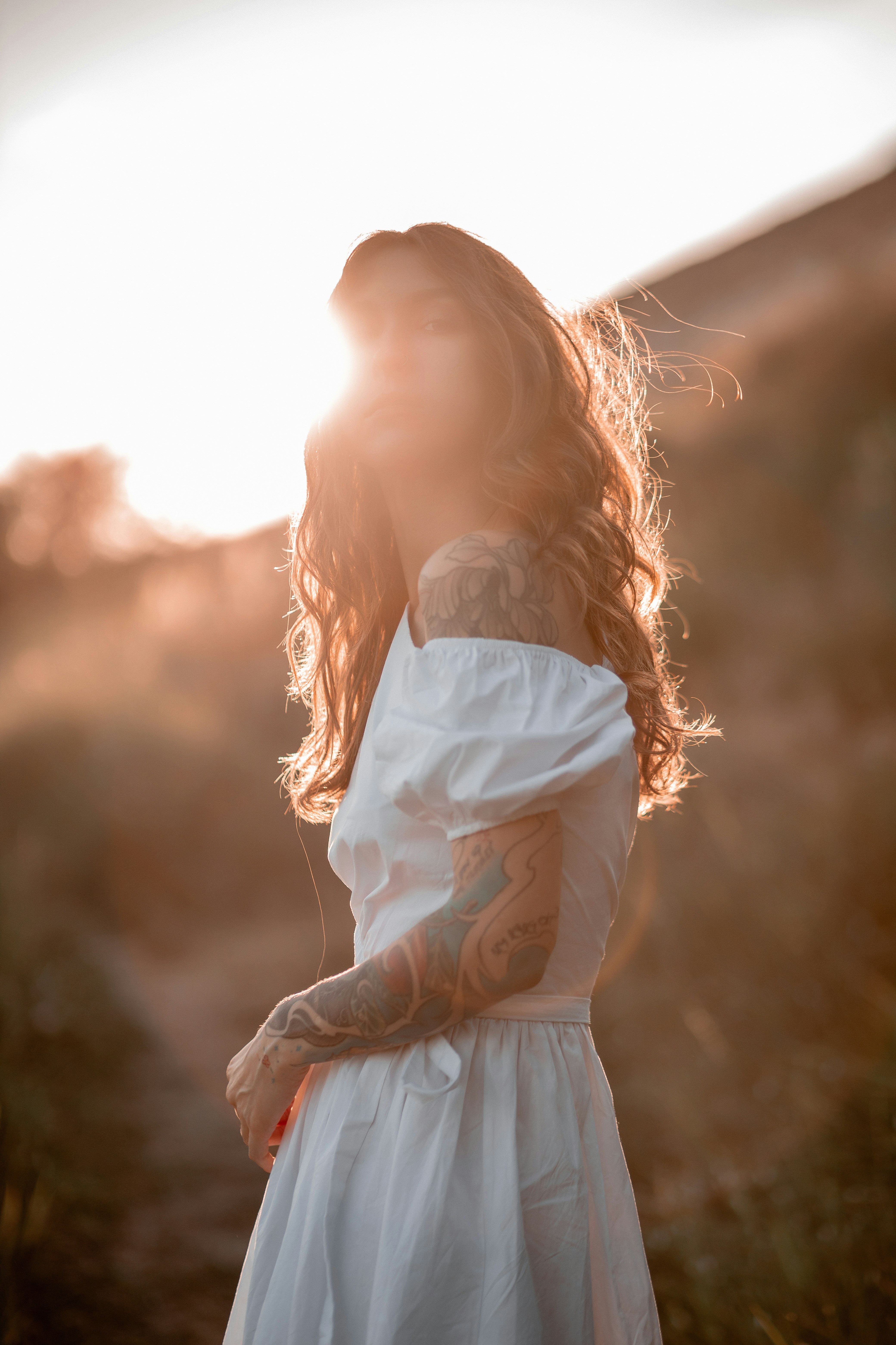 A woman in a white dress standing in a field