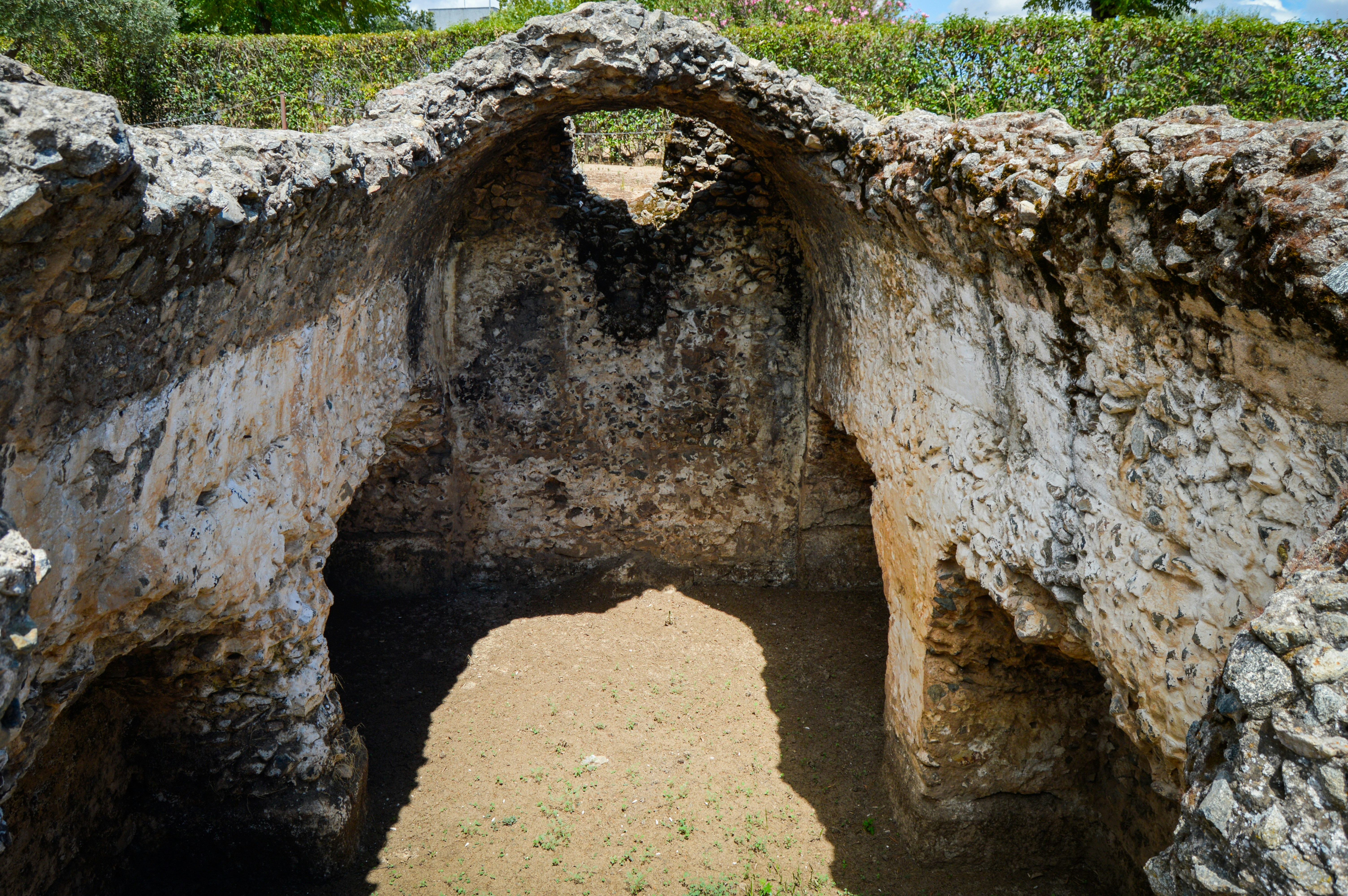 A large stone structure with a hole in it, 