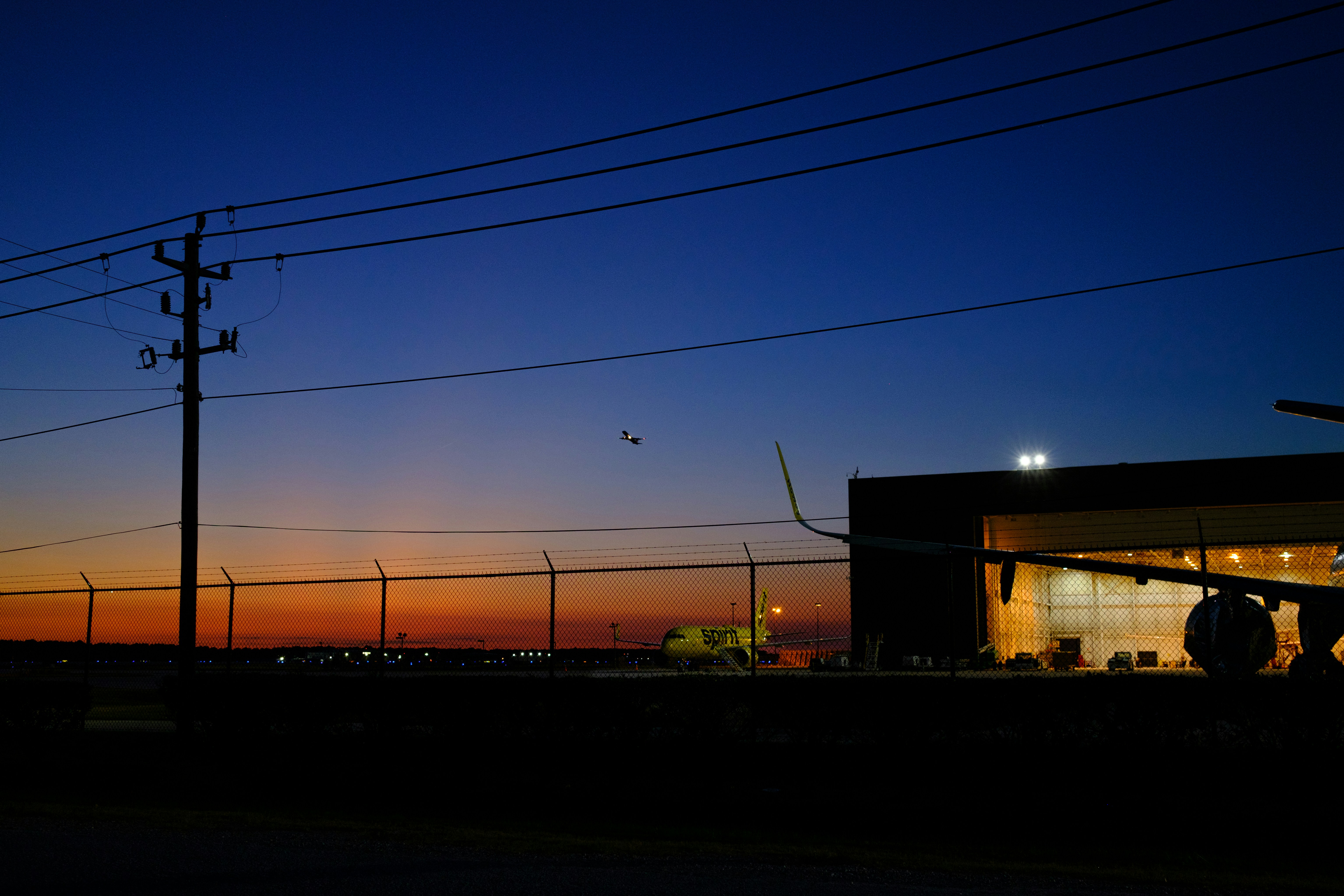 A gas station at night with the sun setting, Spirit Airlines Maintenance Hangar at IAH Houston Airport