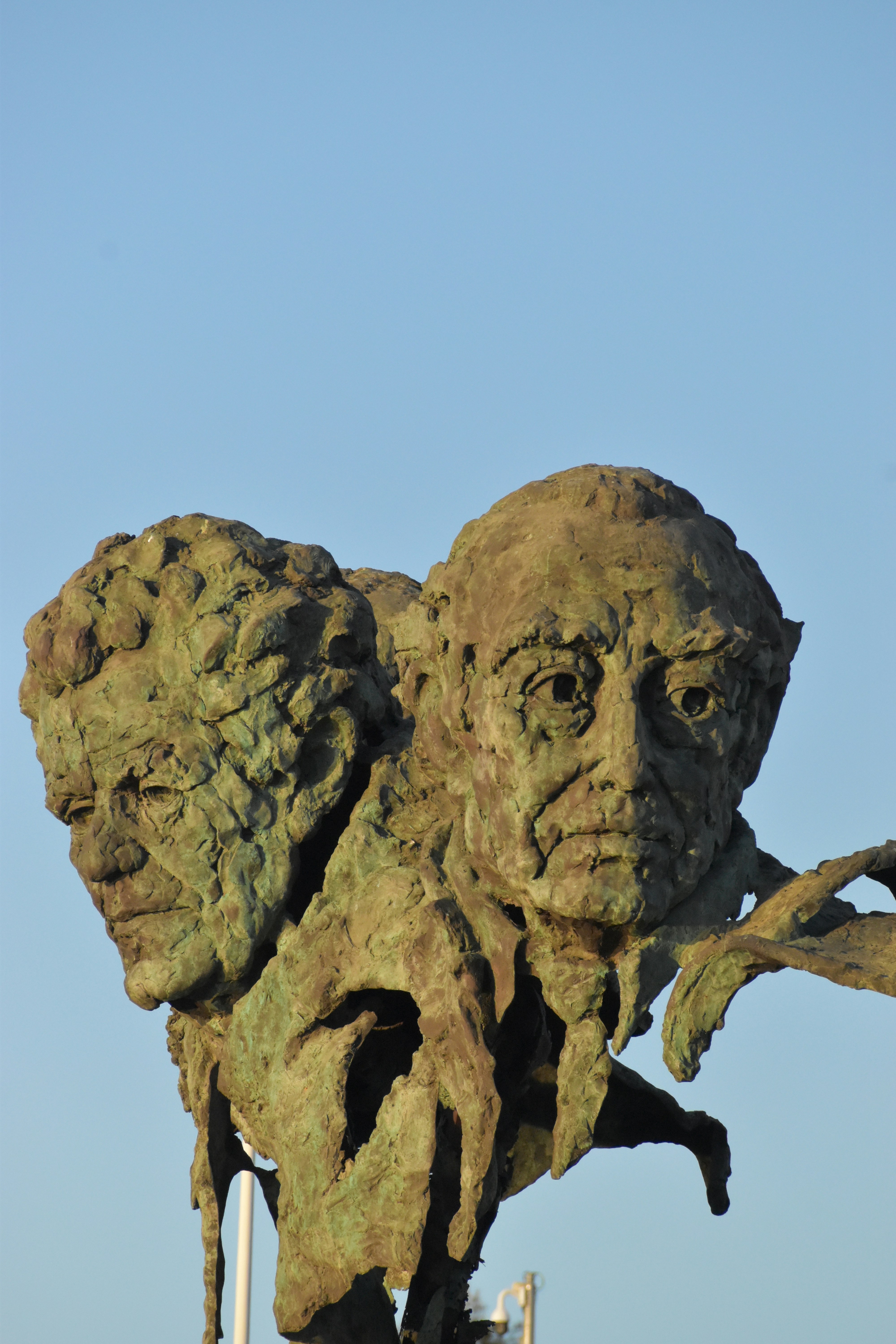 A statue of a man holding a plant in his hands