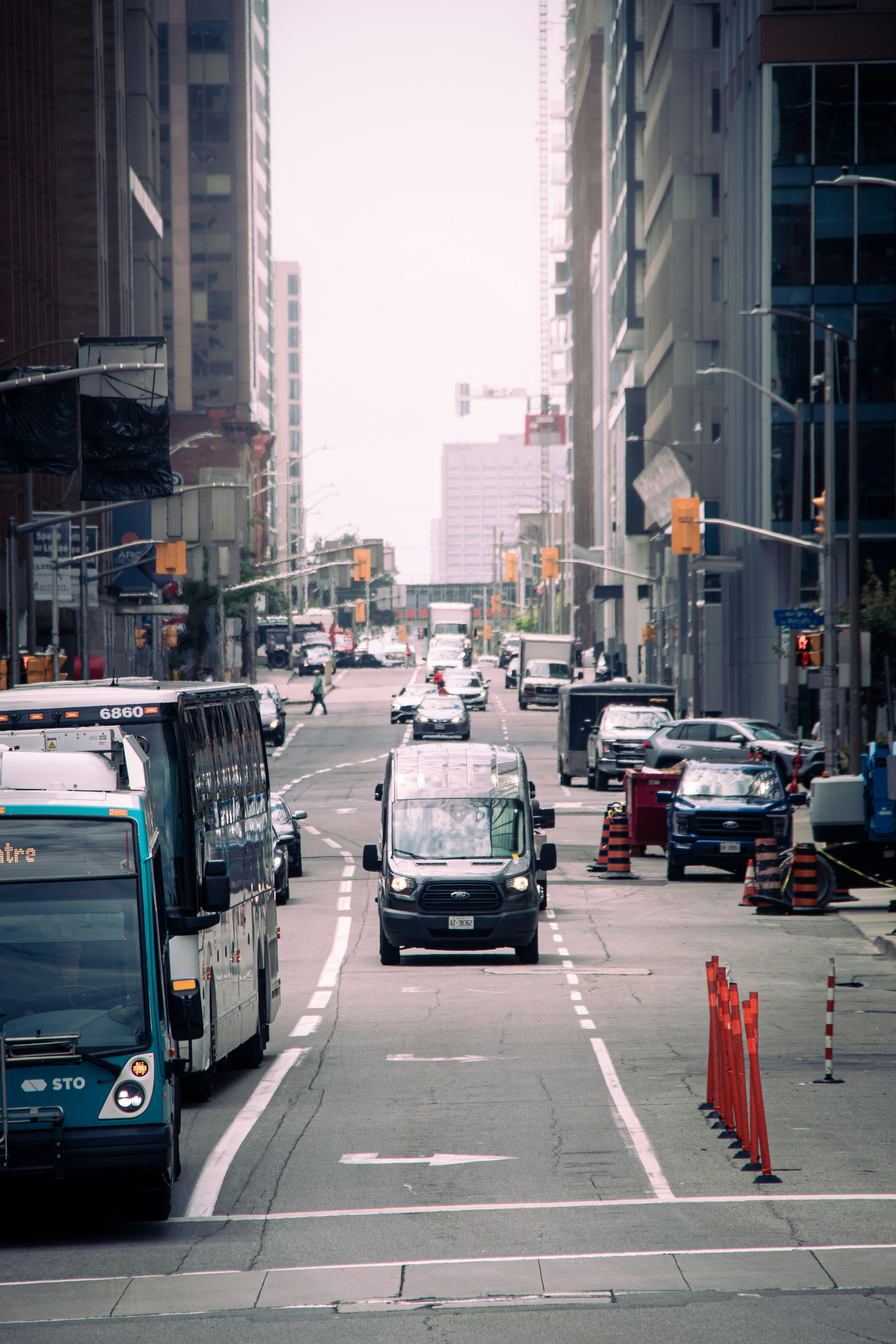 A city street filled with traffic next to tall buildings photo – Free ...