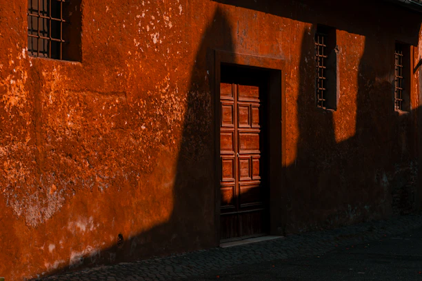 A red building with a clock on the side of it
