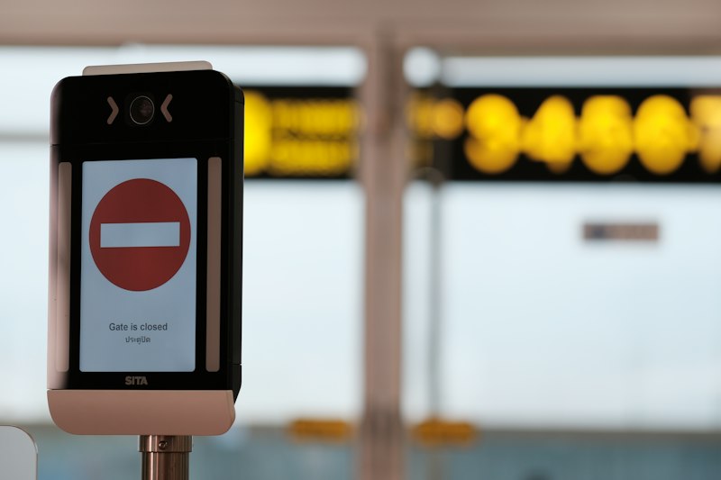 A cell phone sitting on top of a metal pole