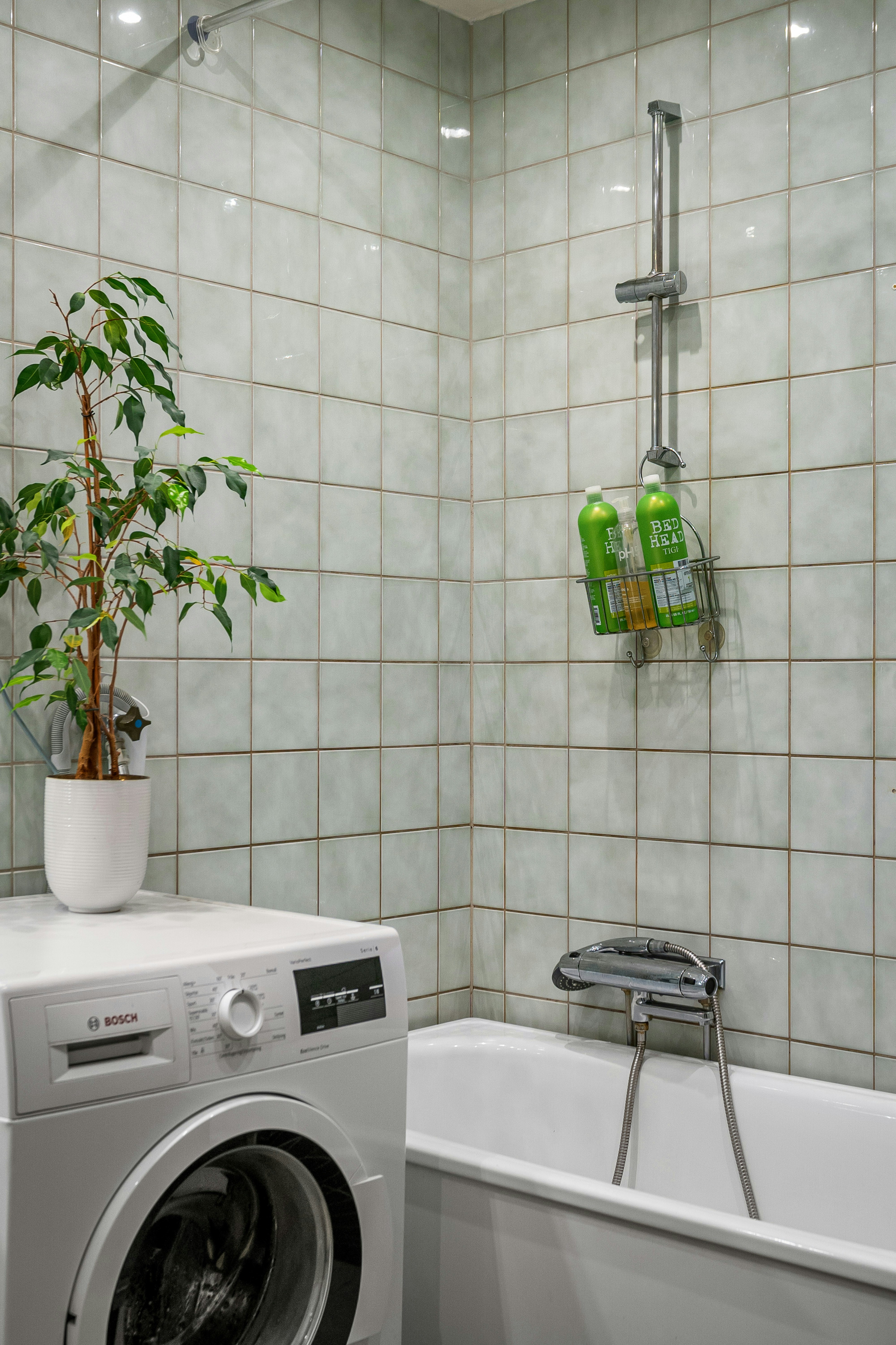 A washer and dryer in a small bathroom