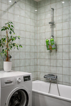 A washer and dryer in a small bathroom