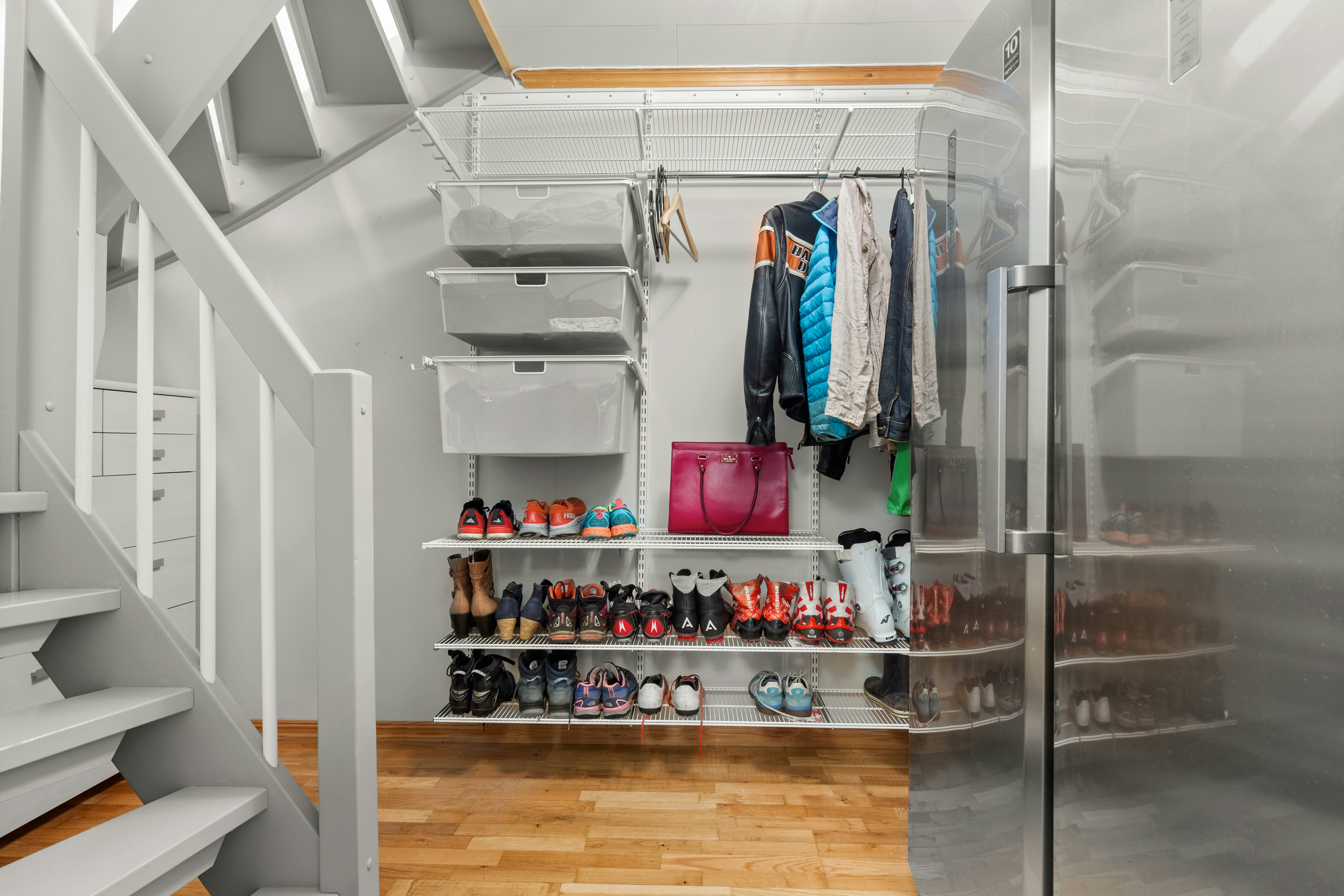 A walk in closet with a lot of shoes