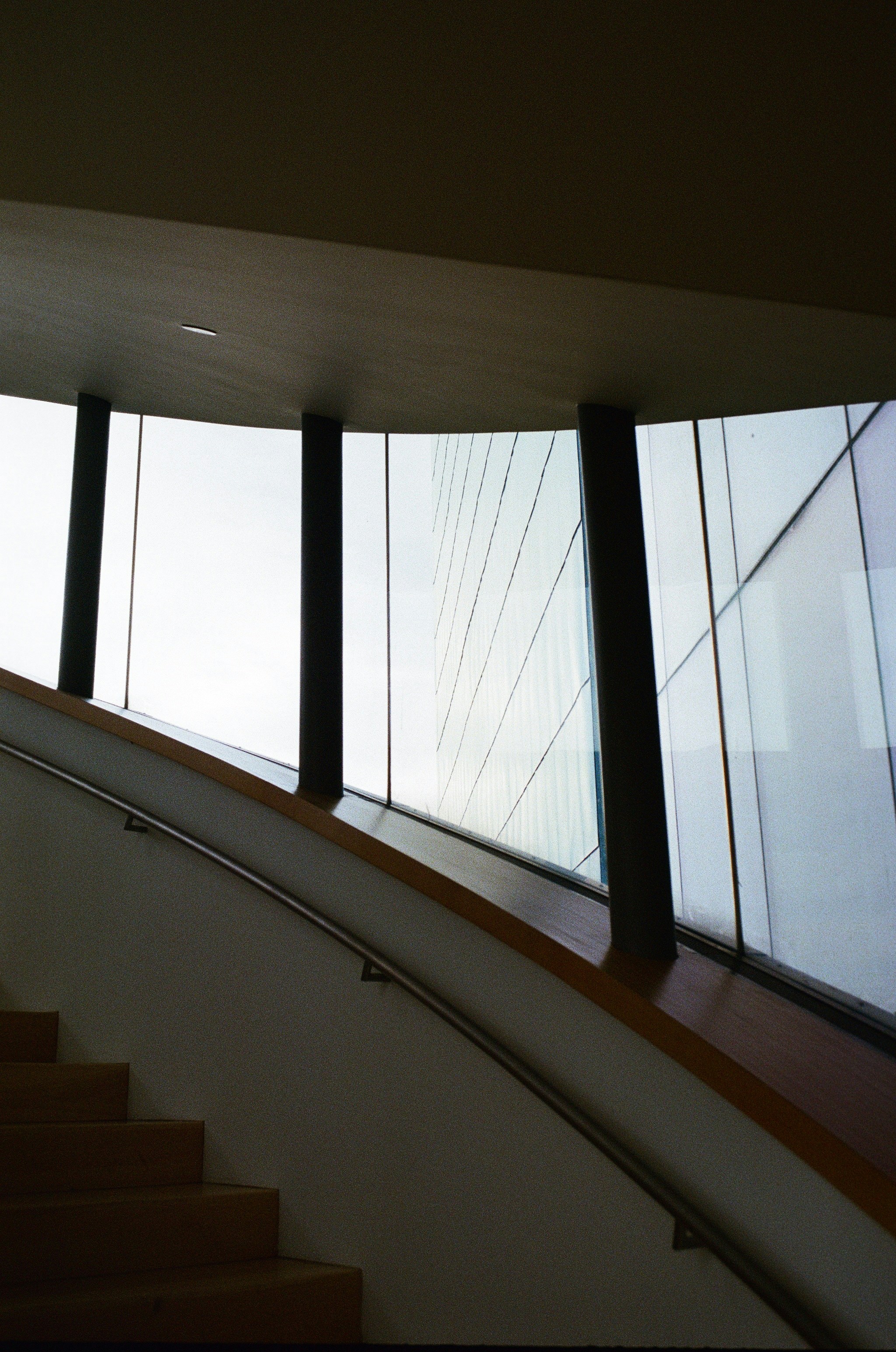 A stair case in a building with a lot of windows