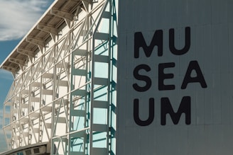 A large white building with a sign on the side of it