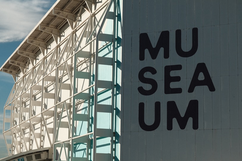 A large white building with a sign on the side of it