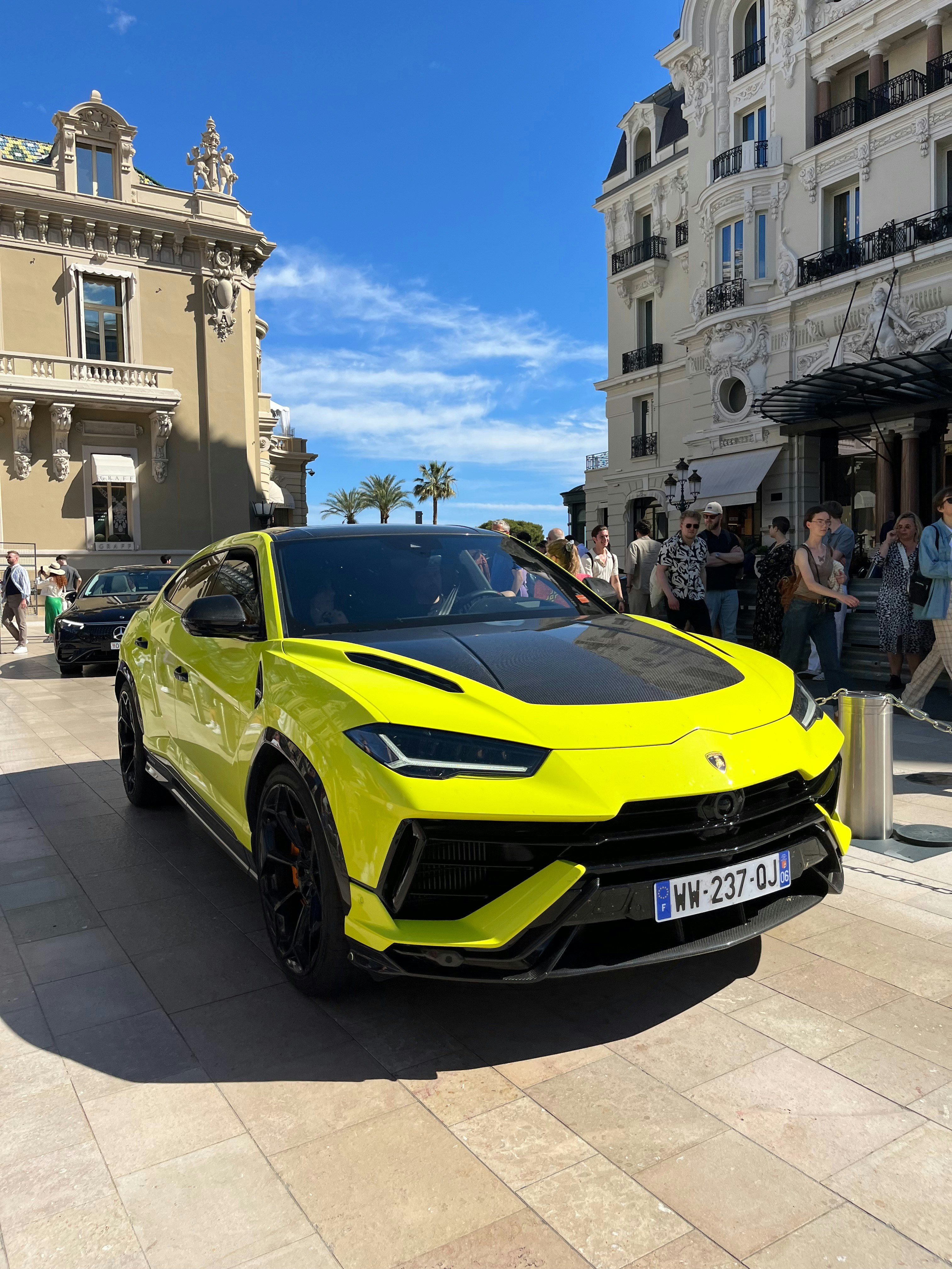 2023 Lamborghini Urus in yellow, parked in front of Italian architecture