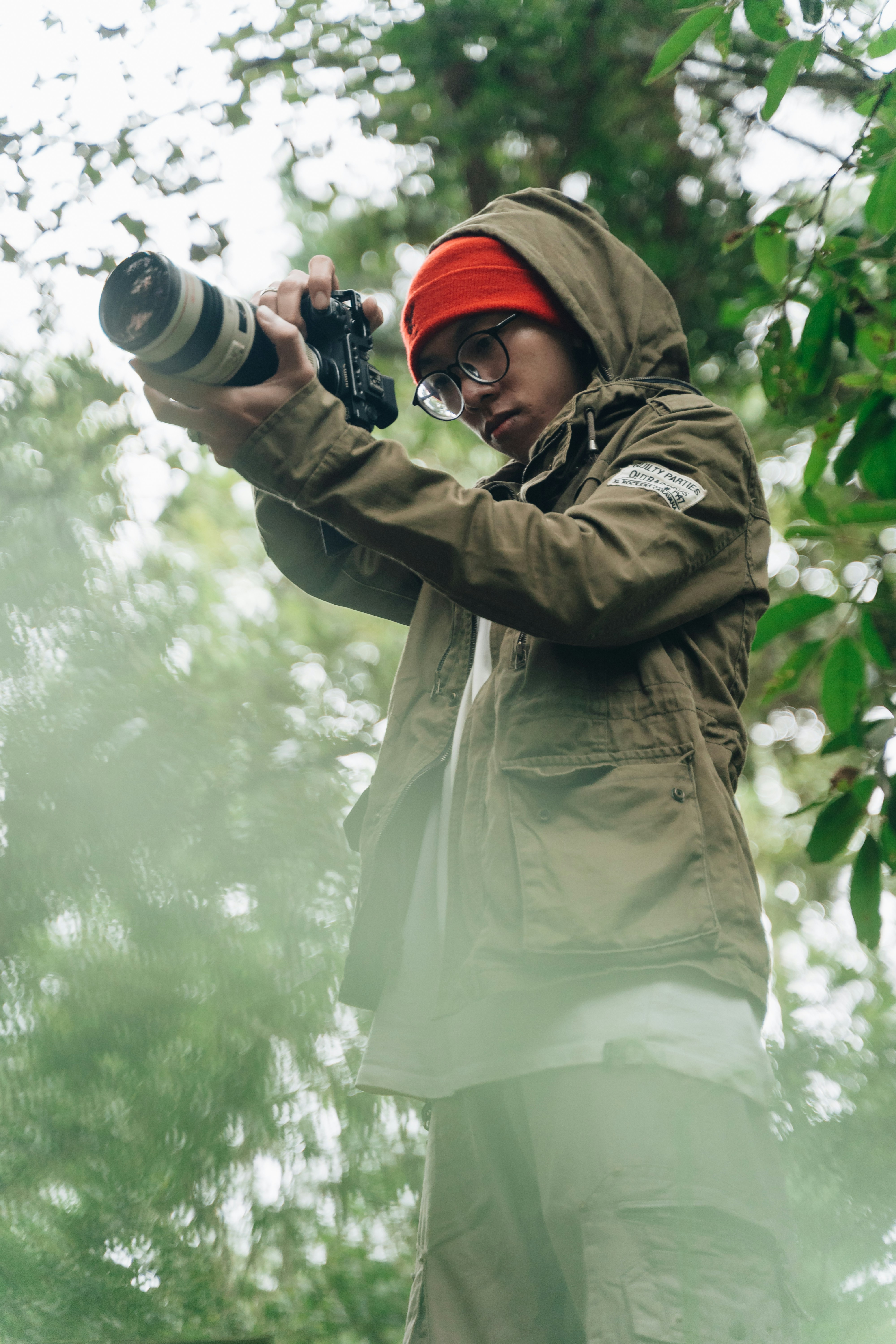 A man holding a camera up to take a picture