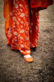 A close up of a person's feet wearing orange shoes