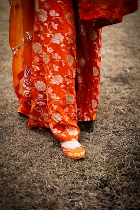 A close up of a person's feet wearing orange shoes