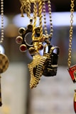 A close up of a bunch of necklaces hanging from chains