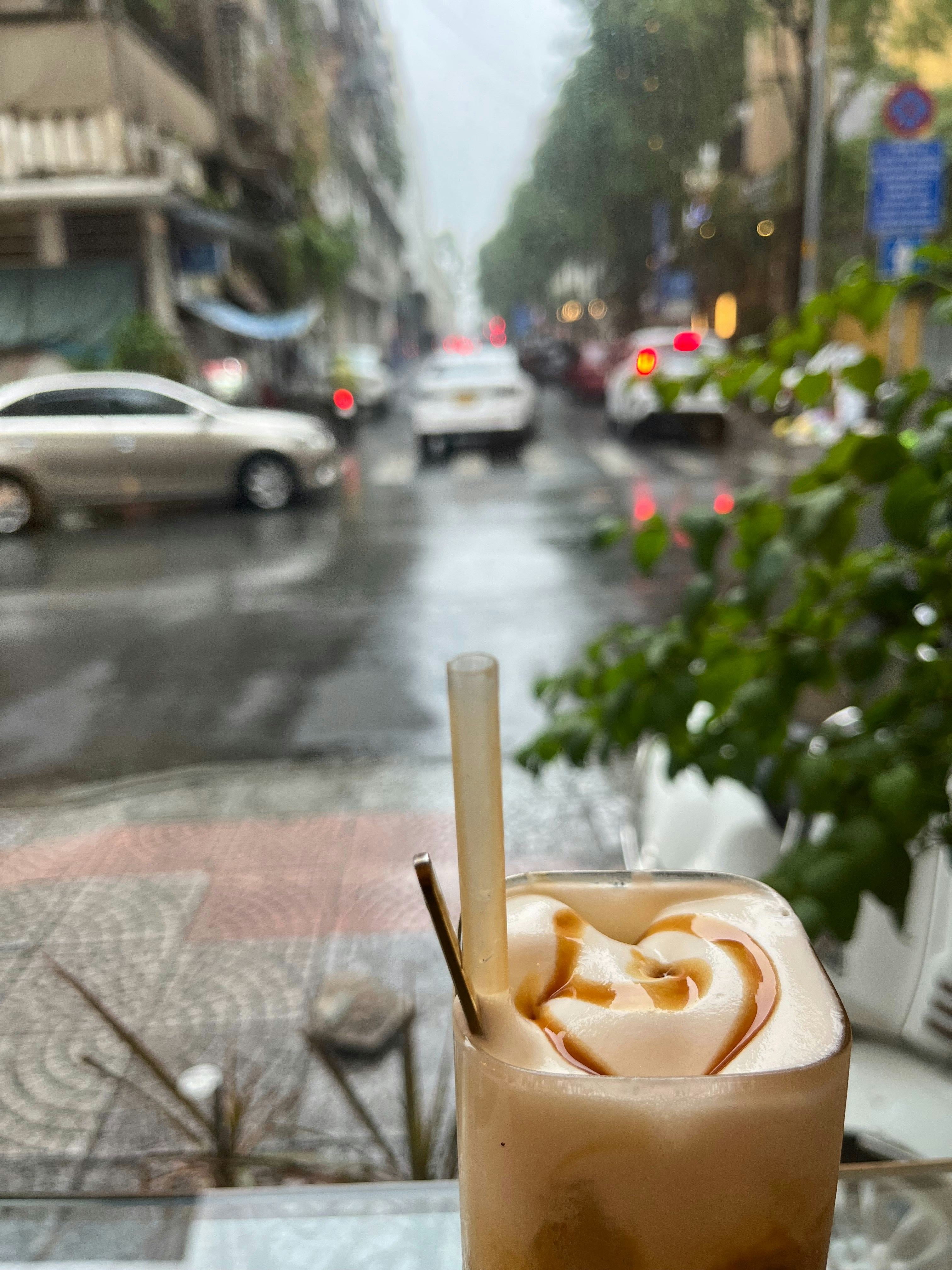 Caramel coffee drink with swirling cream, golden brown tones, dessert coffee aesthetic
