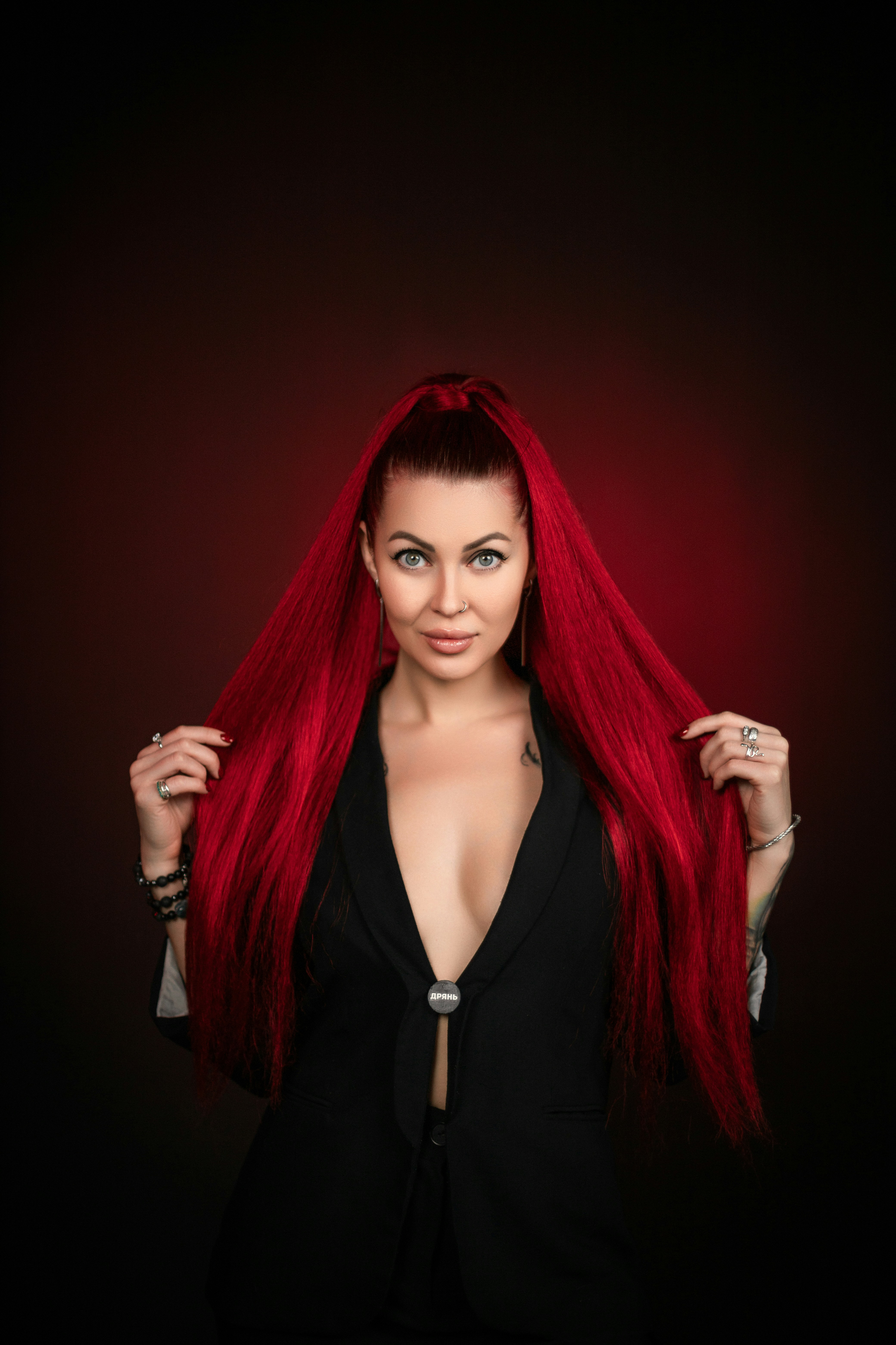 A woman with long red hair posing for a picture