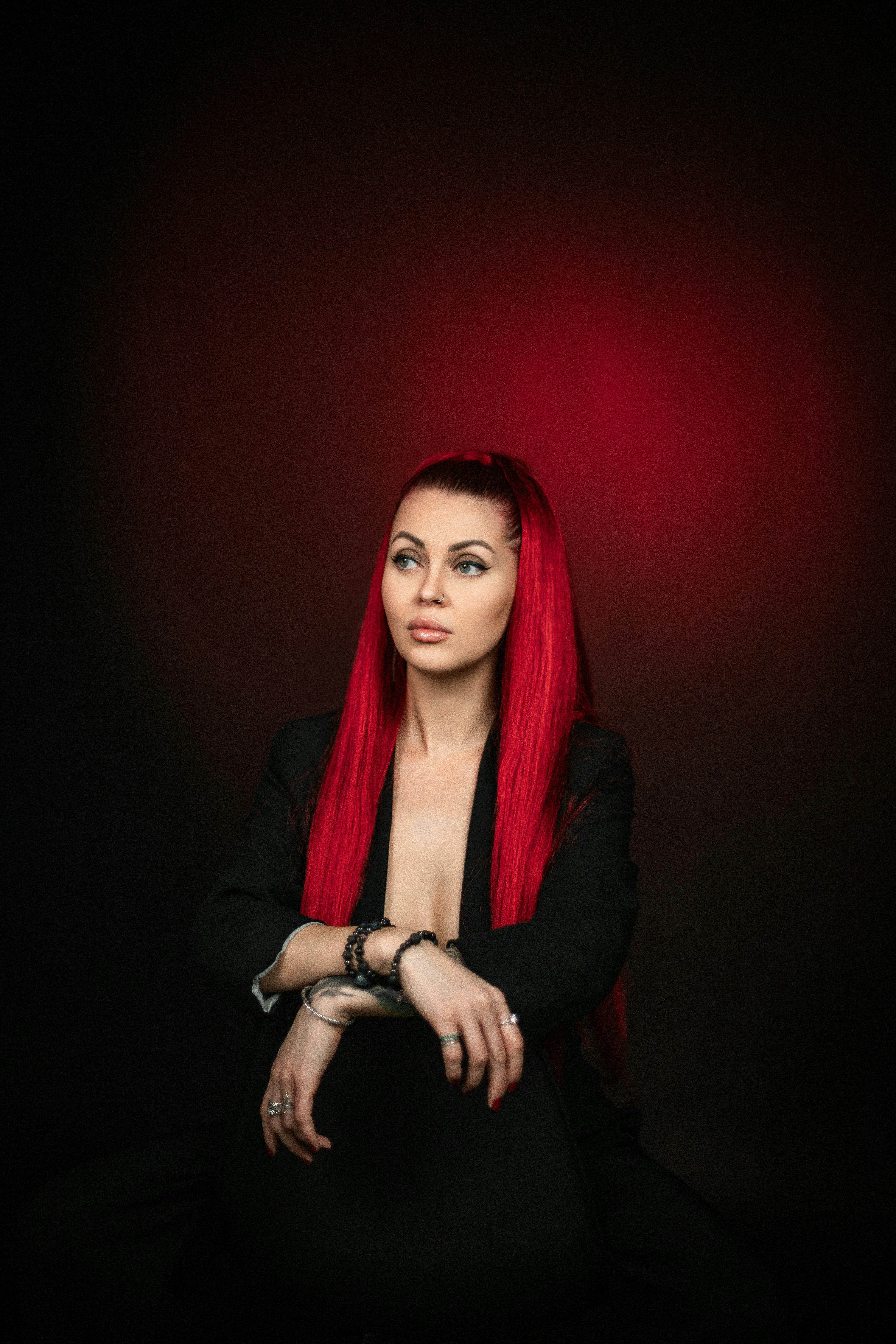 A woman with red hair sitting in a chair