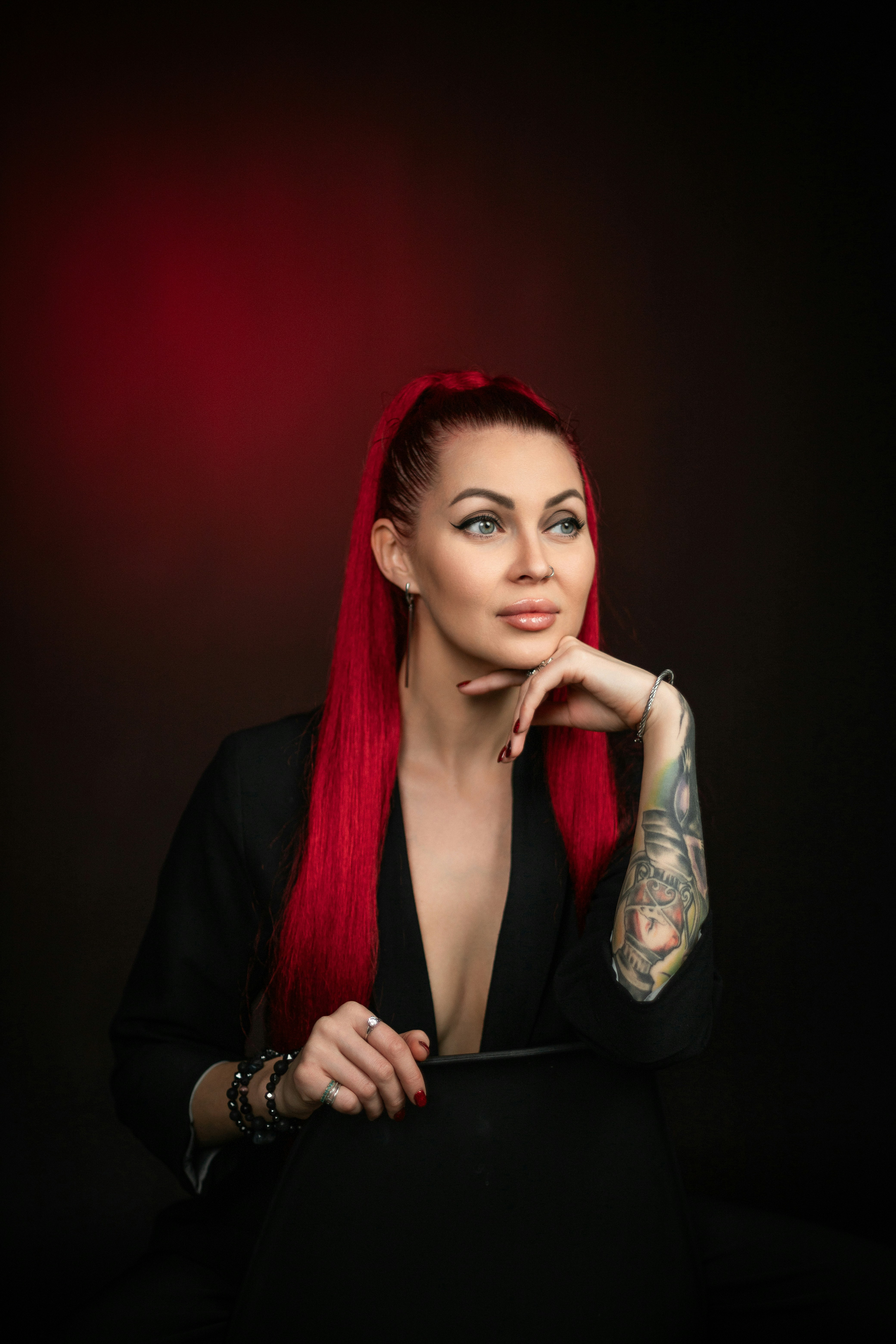 A woman with red hair is posing for a picture