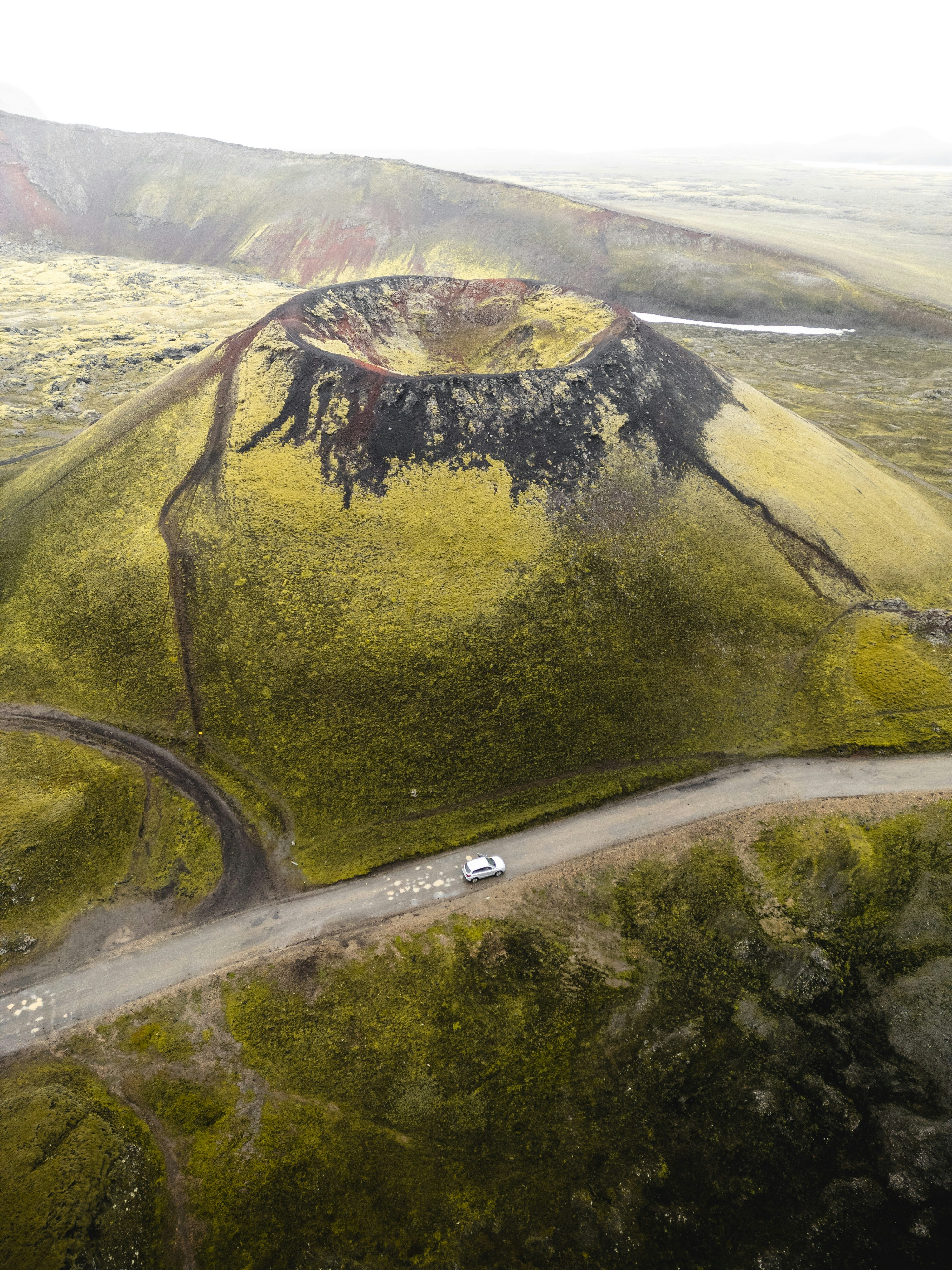 An aerial view of a winding road in the mountains photo – Free Road ...