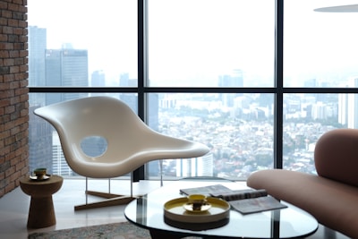 A living room with a large window overlooking a city