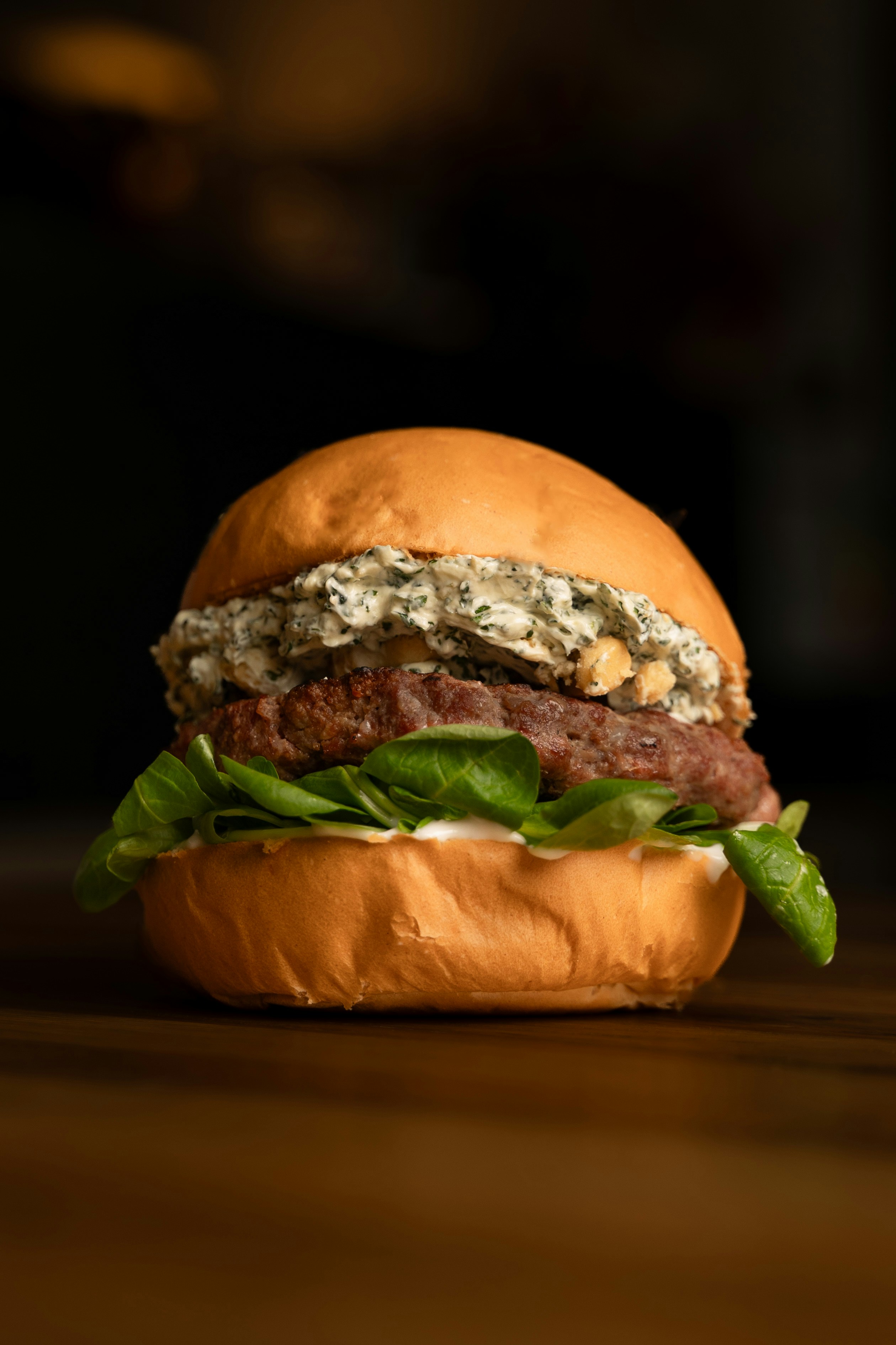 A hamburger sitting on top of a wooden table