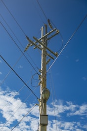 A telephone pole with a clock on it