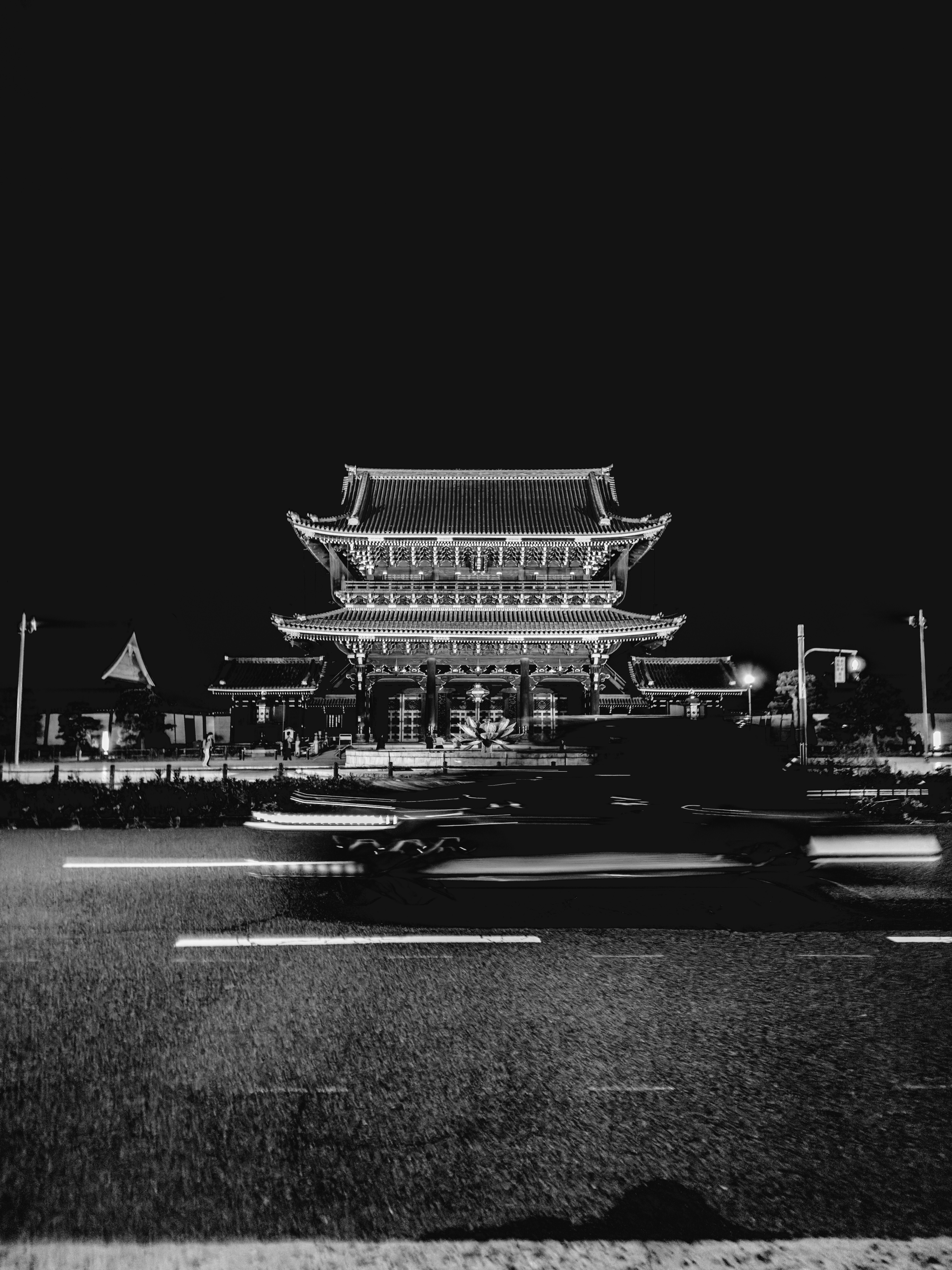 A black and white photo of a building at night