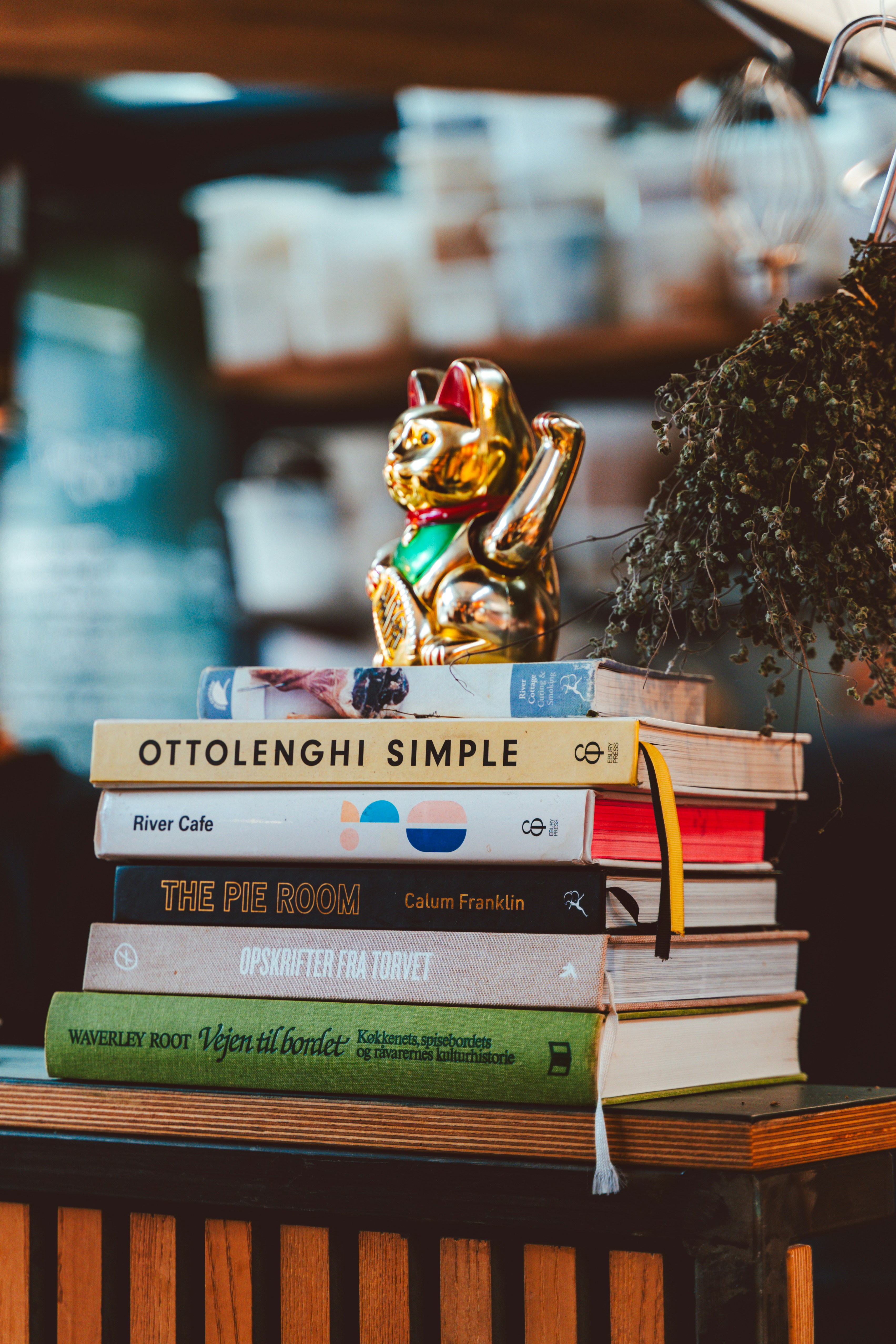 A stack of books sitting on top of a wooden table
