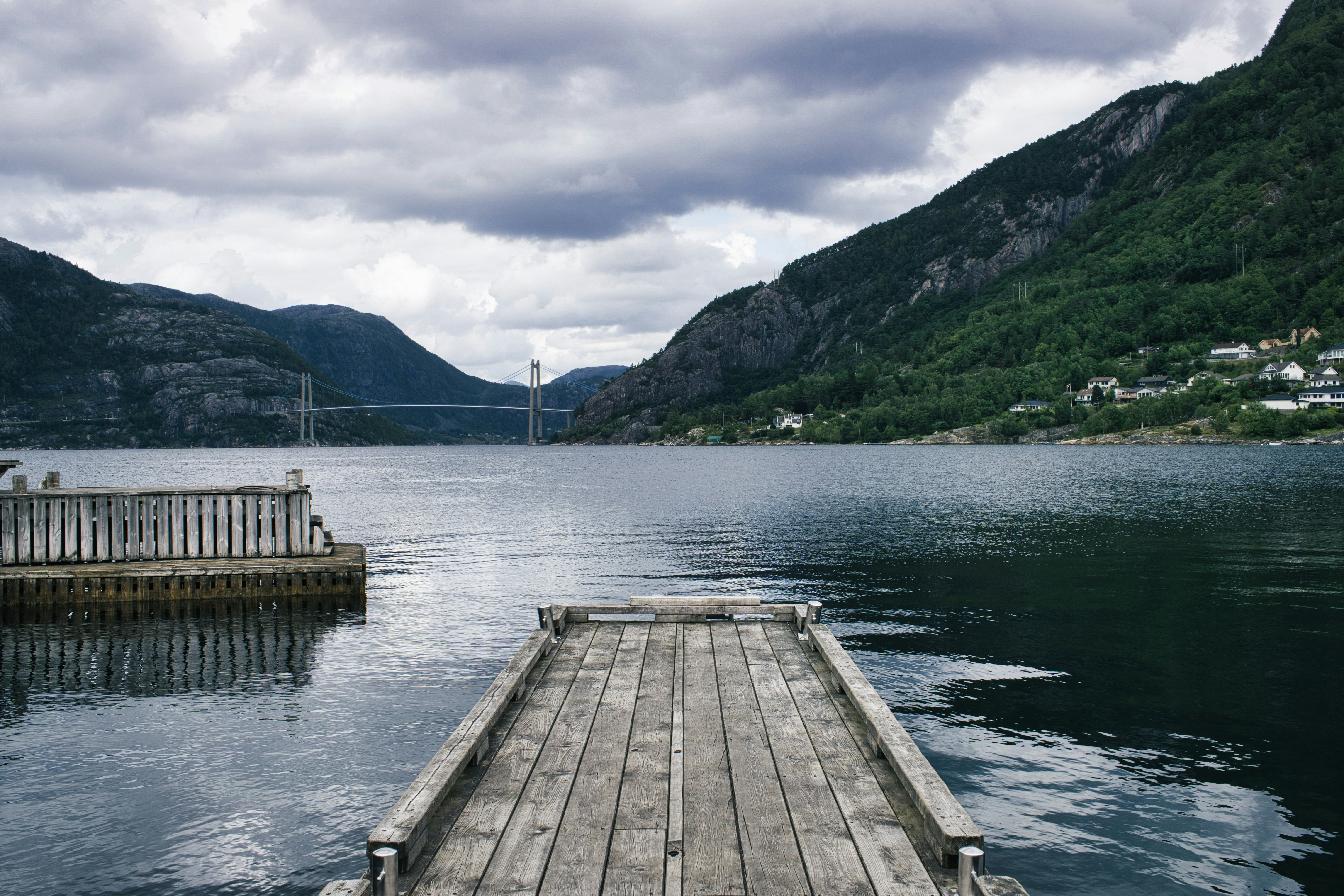 A dock on a lake with mountains in the background