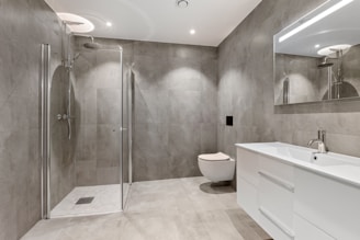 A bathroom with a toilet, sink, and shower