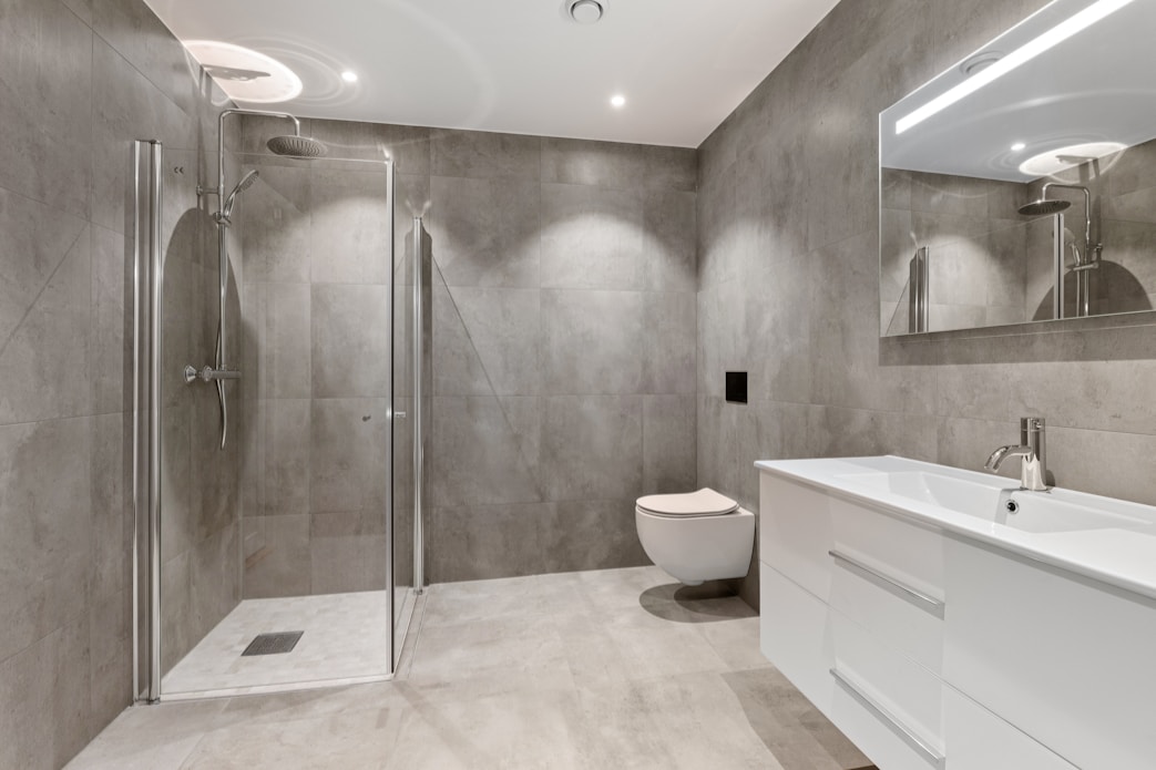 A bathroom with a toilet, sink, and shower