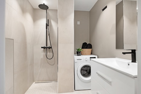 A bathroom with a washer and dryer in it