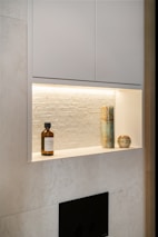 A bathroom with a white wall and a fireplace