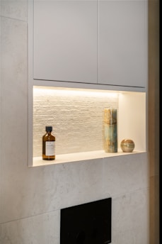 A bathroom with a white wall and a fireplace