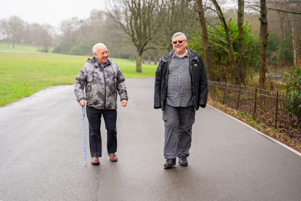 Two senior men enjoying a walk together outdoors