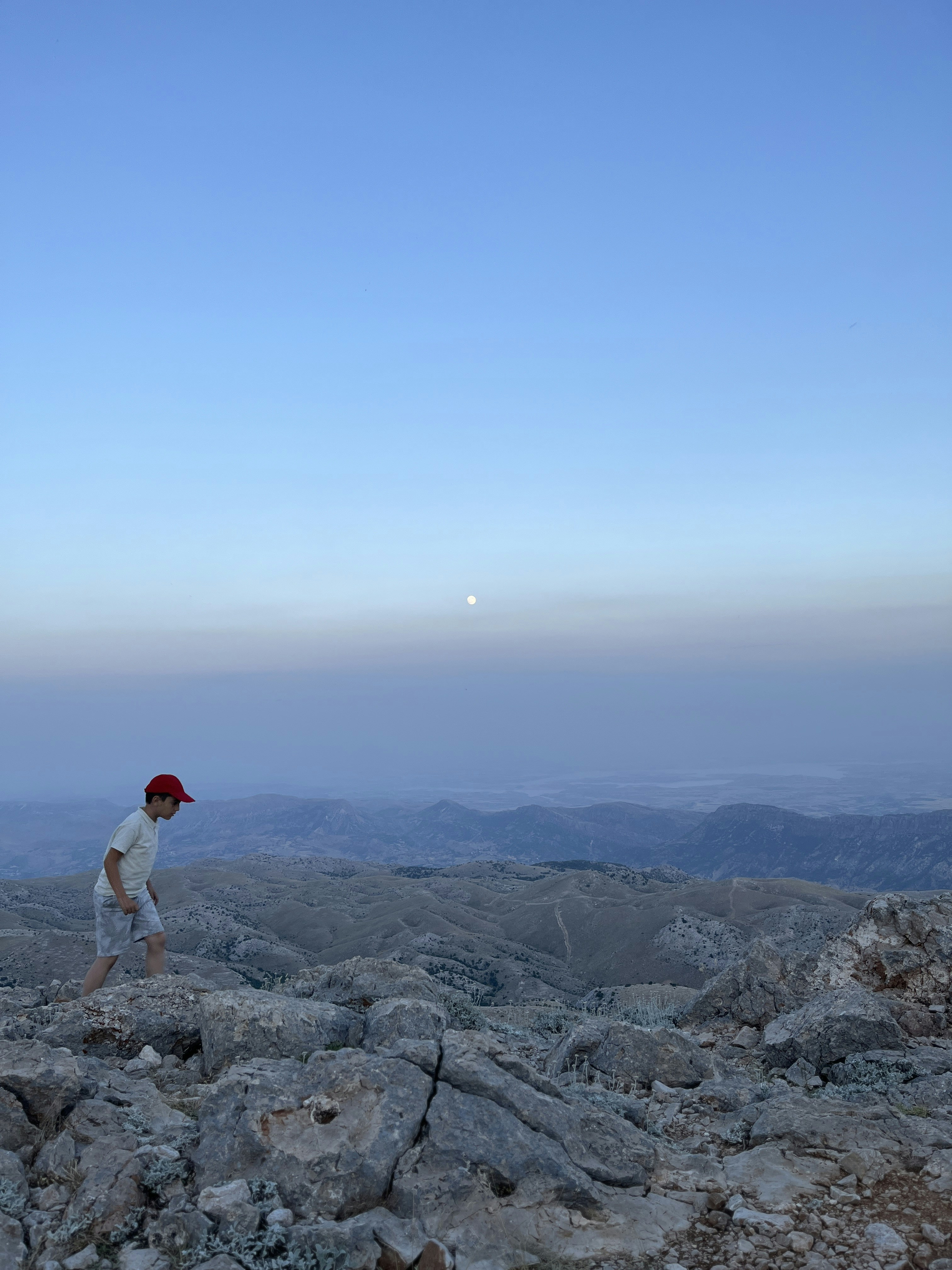 A man standing on top of a rocky hillside