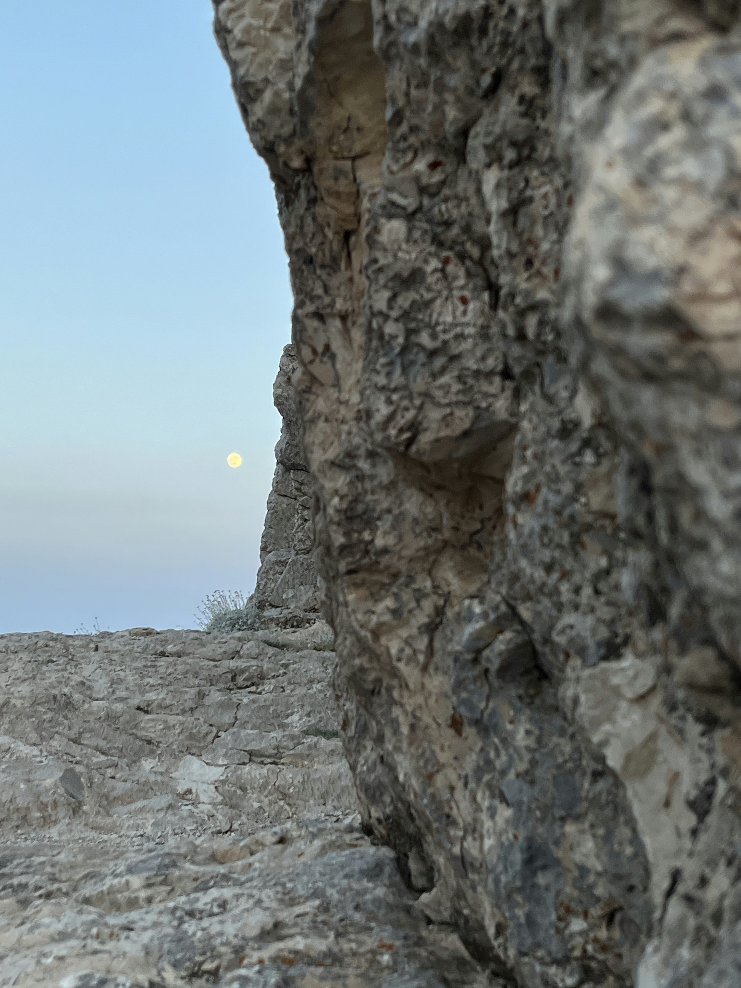 A person standing on top of a rocky cliff