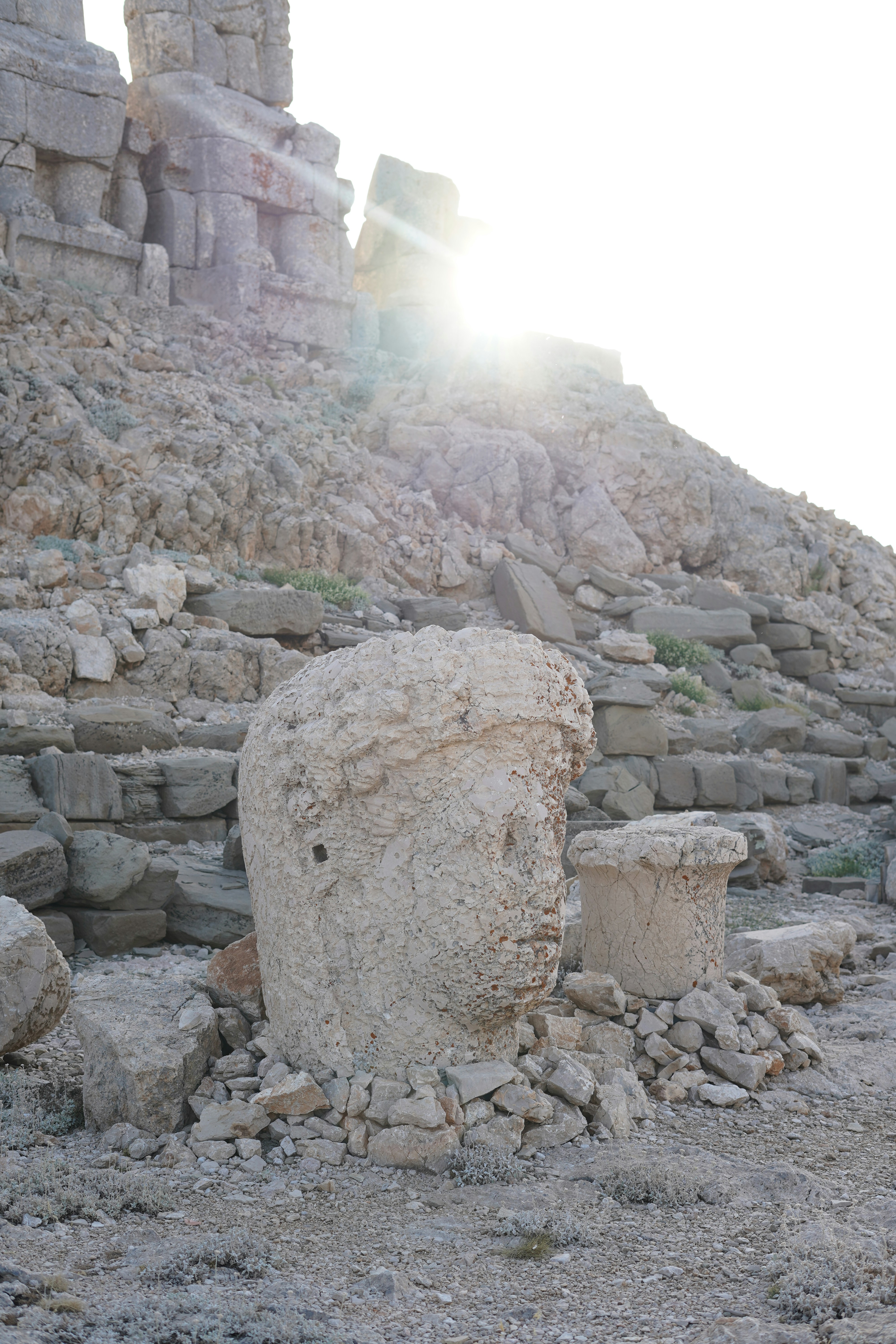 A large stone structure sitting on top of a rocky hillside