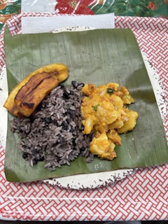 A plate of food on a red and white table cloth