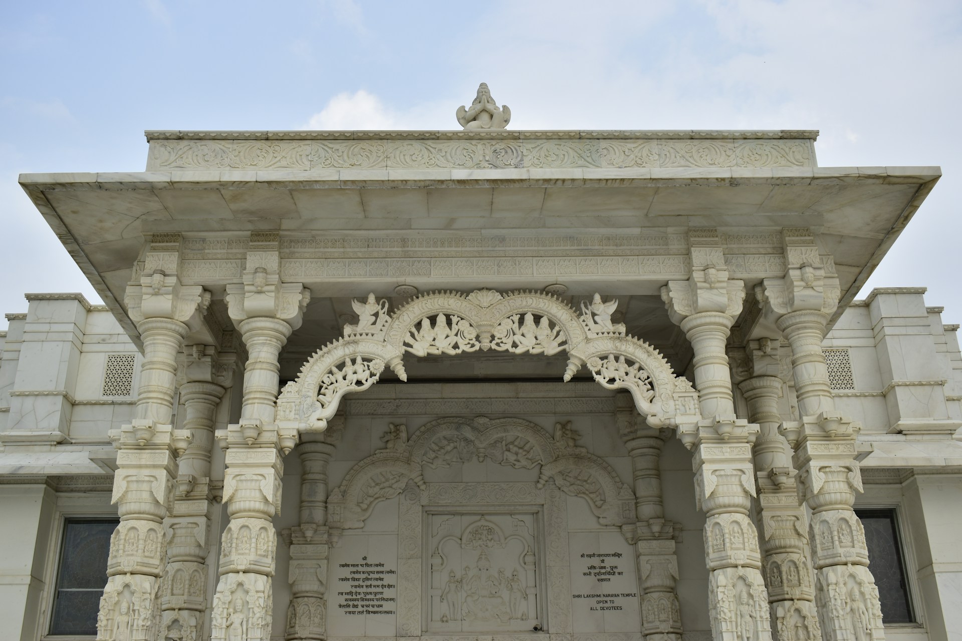 A large white building with a clock on it's side